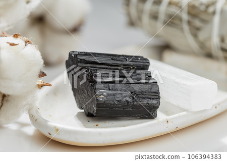 Black Tourmaline Crystal on the White Ceramic Tray Black Tourmaline Crystal on the White Ceramic Tray 106394383