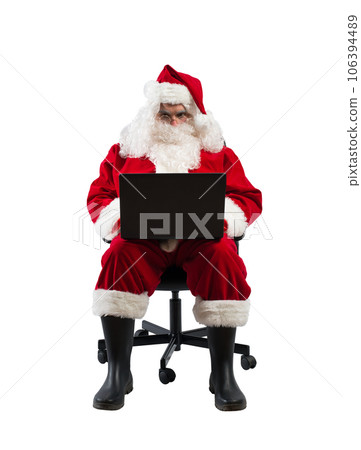 santa claus works with his laptop for christmas santa claus works with his laptop for christmas 106394489