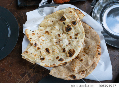 Indian Flat Bread Closeup, Traditional Flatbread also Known as Pita Bread, Roti, Chapati, Naan or Tortilla Indian Flat Bread Closeup, Traditional Flatbread also Known as Pita Bread, Roti, Chapati, Naan or Tortilla 106394917