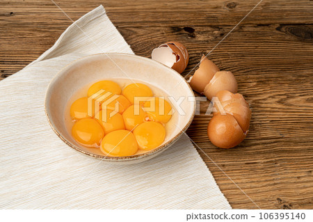 Egg Yolks in Bowl, Fresh Chicken Egg Yolk Separated from Whites for Cooking Recipe, Organic Yolks Top View Egg Yolks in Bowl, Fresh Chicken Egg Yolk Separated from Whites for Cooking Recipe, Organic Yolks Top View 106395140