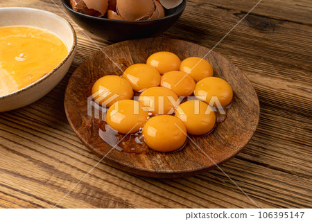 Egg Yolks in Bowl, Fresh Chicken Egg Yolk Separated from Whites for Cooking Recipe, Organic Yolks Top View Egg Yolks in Bowl, Fresh Chicken Egg Yolk Separated from Whites for Cooking Recipe, Organic Yolks Top View 106395147