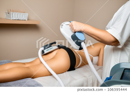A spa salon professional employs her expertise to perform body sculpting on her clients buttocks, aiming for a transformative outcome. 106395444