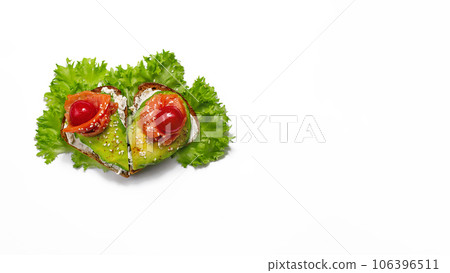 sandwich of heart shaped grain bread curd cheese, avocado salmon, lettuce, cherry tomatoes sesame on white background sandwich of heart shaped grain bread curd cheese, avocado salmon, lettuce, cherry tomatoes sesame on white background 106396511