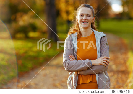 Portrait of smiling woman in fitness clothes in park relaxing Portrait of smiling woman in fitness clothes in park relaxing 106396746