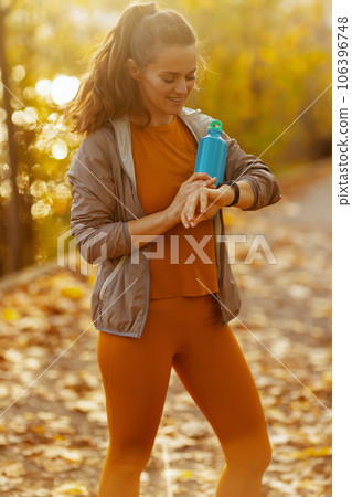 happy modern woman in fitness clothes in park 106396748