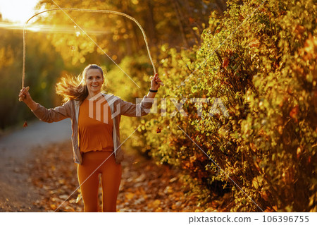 happy fit woman in fitness clothes in park workout 106396755