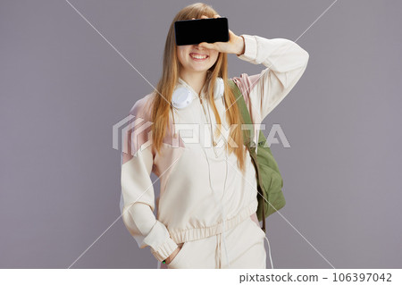 smiling trendy pupil showing smartphone blank screen smiling trendy pupil showing smartphone blank screen 106397042