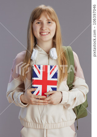 Portrait of smiling trendy pupil in beige tracksuit 106397046