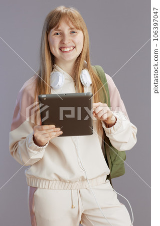 happy trendy girl in beige tracksuit with backpack 106397047