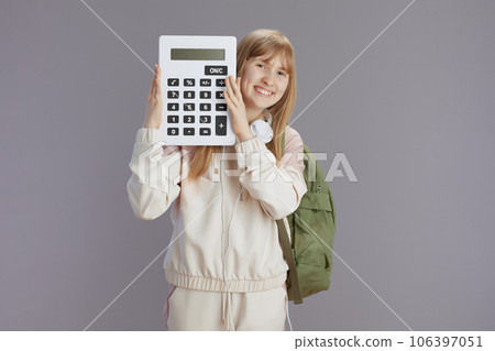 smiling trendy teen girl in beige tracksuit with backpack smiling trendy teen girl in beige tracksuit with backpack 106397051