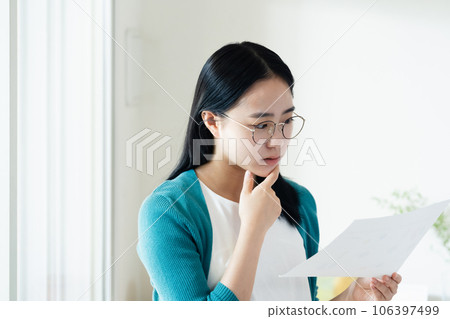 Young woman looking at paperwork Young woman looking at paperwork 106397499
