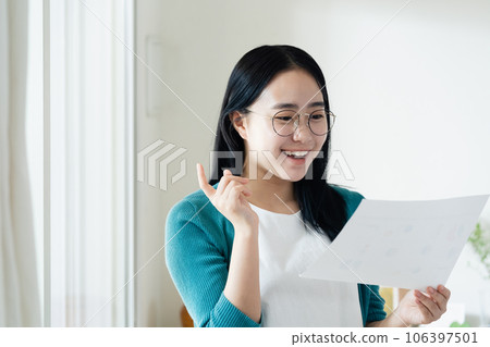 Young woman looking at paperwork 106397501