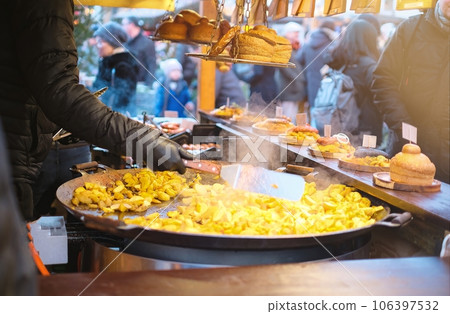 Close-up of Christmas market street food featuring rustic potatoes, burgers, and traditional Estonian dishes Close-up of Christmas market street food featuring rustic potatoes, burgers, and traditional Estonian dishes 106397532