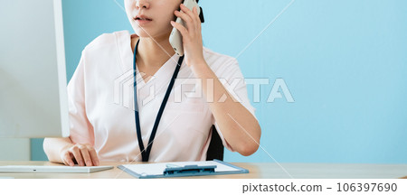 Medical staff answering the phone Medical staff answering the phone 106397690