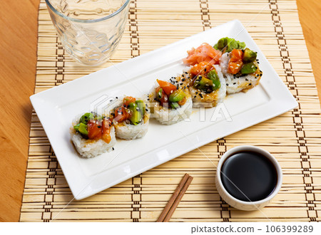 Saketaki roll served with soya sauce and wasabi in a plate 106399289