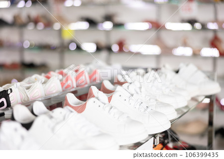 Shelves with different sport shoes in shoes shop 106399435