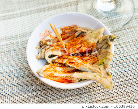 Fried anchovies with herbs served on platter Fried anchovies with herbs served on platter 106399436
