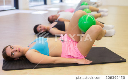 Young woman doing exercises with pilates ball 106399450