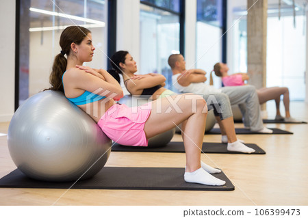 Young woman training pilates at group class 106399473