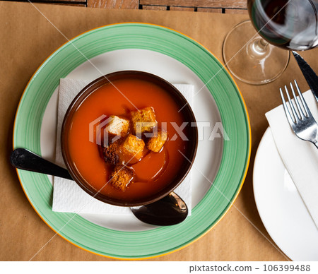 Creamy carrot puree soup served with golden crispy croutons 106399488