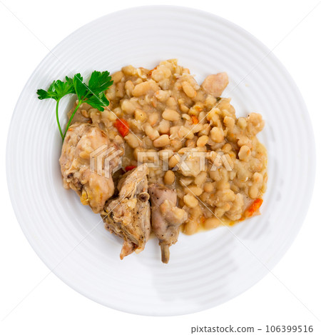 Oven-baked rabbit leg with braised beans in bowl, top view. Oven-baked rabbit leg with braised beans in bowl, top view. 106399516