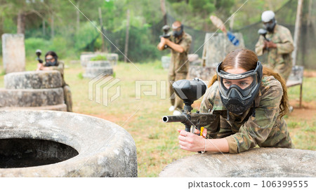 Portrait of girl in camouflage on paintball field Portrait of girl in camouflage on paintball field 106399555