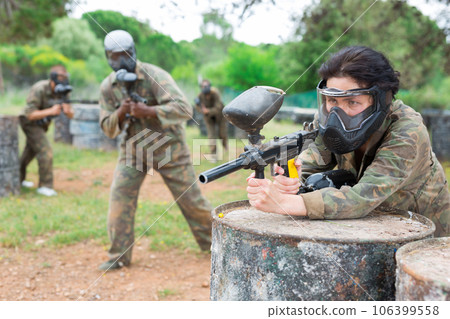 Portrait of asian female with gun on paintball field 106399558