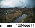 Above aerial shot of green pine forests and yellow foliage groves with beautiful texture of golden treetops. Beautiful fall season scenery in evening. Mountains in autumn colors in golden time 106400011