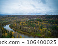 Above aerial shot of green pine forests and yellow foliage groves with beautiful texture of golden treetops. Beautiful fall season scenery in evening. Mountains in autumn colors in golden time 106400025