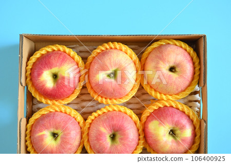 beautiful pink apple in the box on blue background beautiful pink apple in the box on blue background 106400925