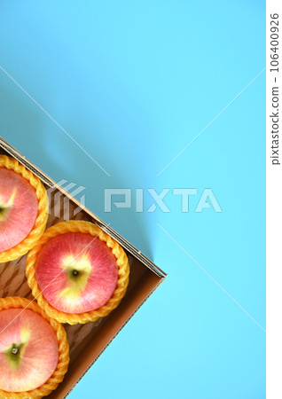 beautiful pink apple in the box on blue background 106400926