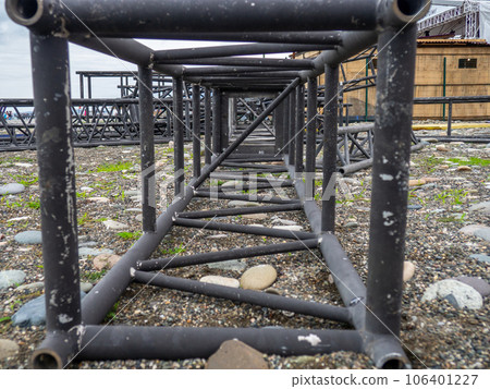 Disassembled frame of a street stage. Disassembled iron structure Stage designer for concerts. Metal constructions. Scrap metal. A bunch of iron. Disassembled frame of a street stage. Disassembled iron structure Stage designer for concerts. Metal constructions. Scrap metal. A bunch of iron. 106401227