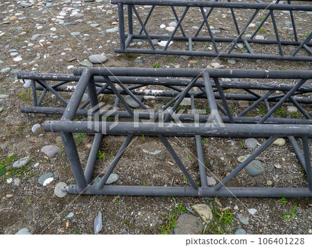 Disassembled frame of a street stage. Disassembled iron structure Stage designer for concerts. Metal constructions. A bunch of iron. Installation work. Disassembled frame of a street stage. Disassembled iron structure Stage designer for concerts. Metal constructions. A bunch of iron. Installation work. 106401228