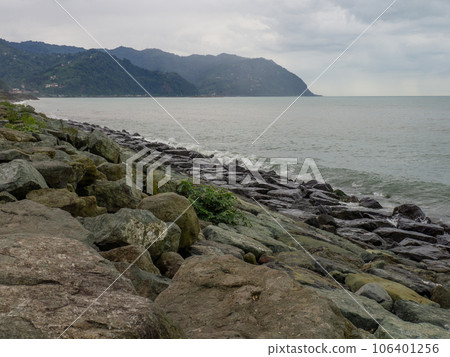 Rocky seashore. The shore is fortified with huge stones. Large waves on the pier. Travel to Turkey. Big wave 106401256