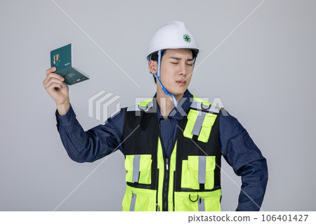 millennials and gen z, korean asian young man, site staff holding a bankbook and pondering 106401427