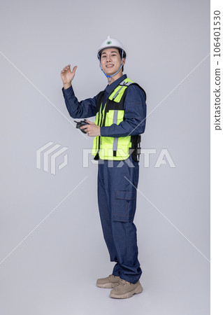 millennials and gen z, korean asian young man, site staff controlling a drone 106401530
