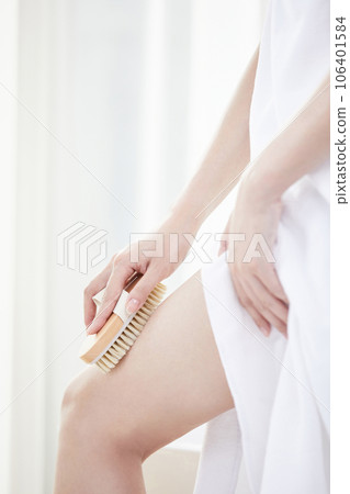 beauty concept photo of korean asain beautiful woman using a brush to scrub her legs beauty concept photo of korean asain beautiful woman using a brush to scrub her legs 106401584