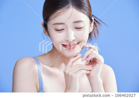 beauty concept photo of korean asain beautiful woman smiling with both hands clasped together 106402027