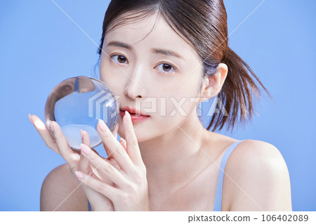 beauty concept photo of korean asain beautiful woman holding a crystal and closing her eyes 106402089