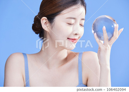 beauty concept photo of korean asain beautiful woman holding a crystal and closing her eyes beauty concept photo of korean asain beautiful woman holding a crystal and closing her eyes 106402094