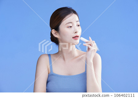 beauty concept photo of korean asain beautiful woman holding a lipbalm 106402111