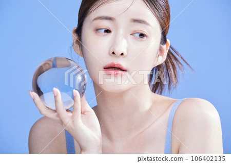 beauty concept photo of korean asain beautiful woman holding a crystal and closing her eyes beauty concept photo of korean asain beautiful woman holding a crystal and closing her eyes 106402135