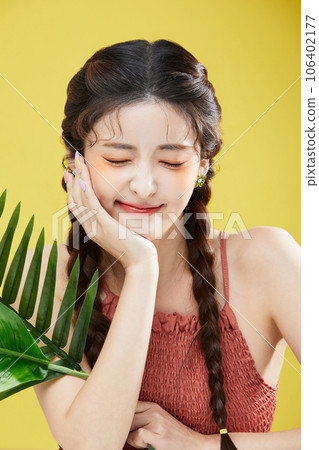 beauty concept photo of korean asain beautiful woman holding a leave and resing her chin 106402177