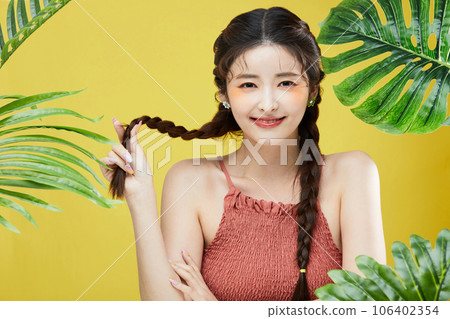 beauty concept photo of korean asain beautiful woman touching her head among the leaves 106402354