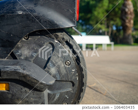 Part of an electric scooter close-up. Broken tire. Broken scooter wheel. Propulsion tool. Part of an electric scooter close-up. Broken tire. Broken scooter wheel. Propulsion tool. 106403435