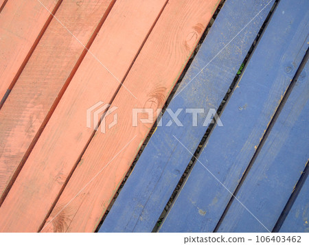 Colored wood flooring. Knocked together boards of blue and red colors. Floor. Board background 106403462