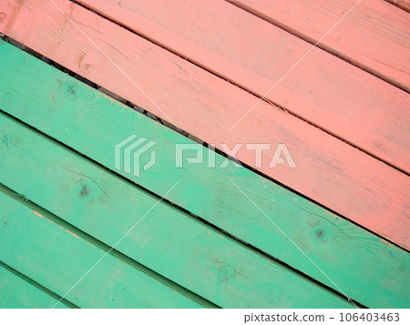 Colored wood flooring. Knocked together boards of red and green colors.  Board background 106403463