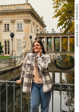 Tourist attraction woman travel enjoying nature sightseeing Baths classicist Palace on the Isle in Lazienki Park touristic place in Warsaw. Lazienki Royal Baths Park, Baroque columns Warsaw Poland Tourist attraction woman travel enjoying nature sightseeing Baths classicist Palace on the Isle in Lazienki Park touristic place in Warsaw. Lazienki Royal Baths Park, Baroque columns Warsaw Poland 106403801