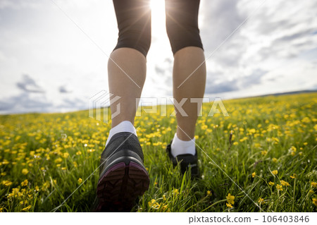 Woman trail runner cross country running at high altitude grassland Woman trail runner cross country running at high altitude grassland 106403846