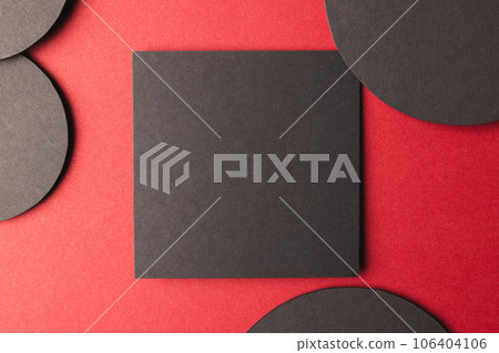 Square and circles of black paper with copy space on red background 106404106